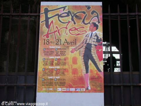 Féria d'Arles poster with a matador, hung on an iron gate