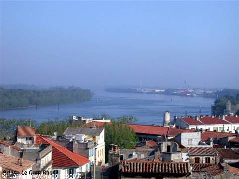 Red rooftops of Arles above the misty Rhône river