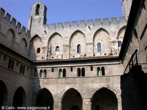 Courtyard of the Popes' Palace in Avignon, stone walls with Gothic arches