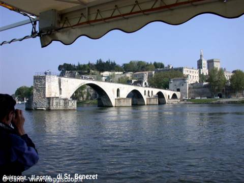 Tourist photographs Avignon's Saint-Bénézet bridge from a Rhône riverboat