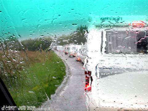 Truck convoy on a wet road seen through the rain-covered window, Luberon