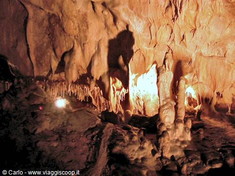 Stalactites and stalagmites illuminated inside a Provence cave