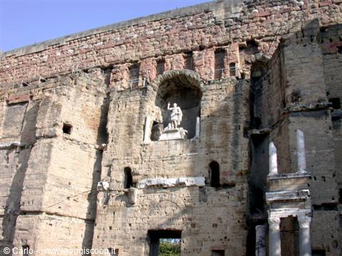 Statue in the niche of Orange Roman theatre, ancient stone wall