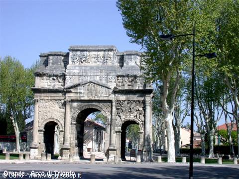 Roman triumphal arch in Orange, stone carvings under blue sky