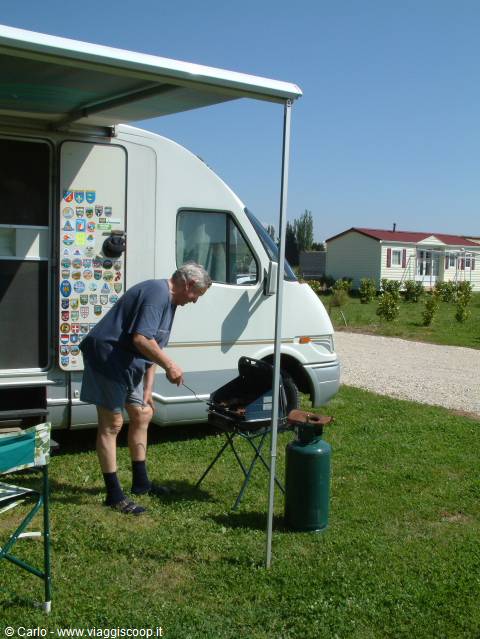 Man grilling beside his motorhome at the Saintes-Maries-de-la-Mer campground, Camargue
