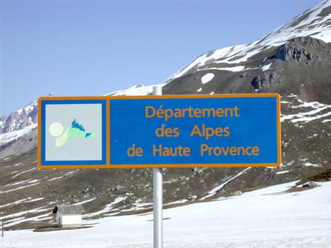Blue road sign of Alpes de Haute Provence among snow and mountains