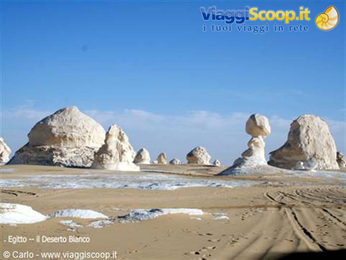 White chalk rock formations in Egypt's White Desert under a clear blue sky