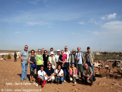 Tour group posing on sandy ground at Dakhla Oasis