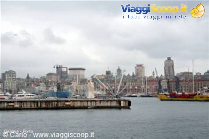 Genoa old harbor: pier, ships and towers under cloudy sky