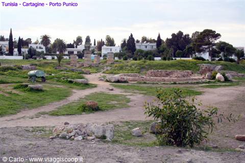 Punic ruins at Carthage, ancient columns and walls among grass and sandy ground