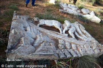 Carved stone relief with figures and animals, at As-Sultan
