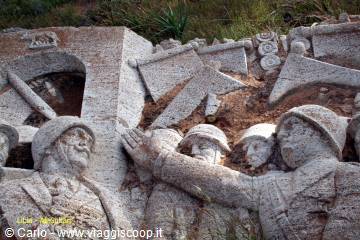 Stone bas-relief of helmeted soldiers, carved monument in daylight