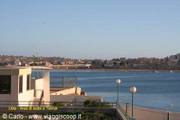 Tobruk lagoon with white houses, lamp posts and a bridge over the bay
