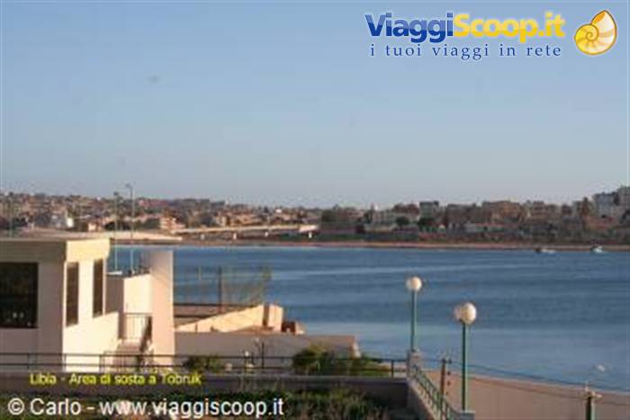 Tobruk lagoon with white houses, lamp posts and a bridge over the bay