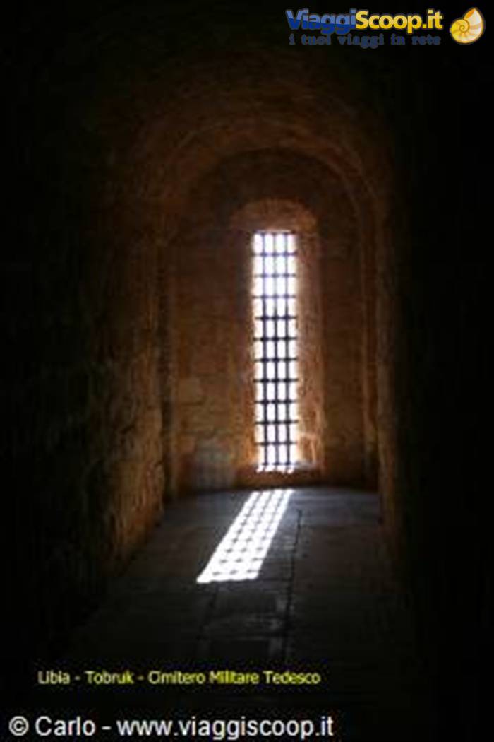Grated stone window in the German war cemetery of Tobruk, sunlight