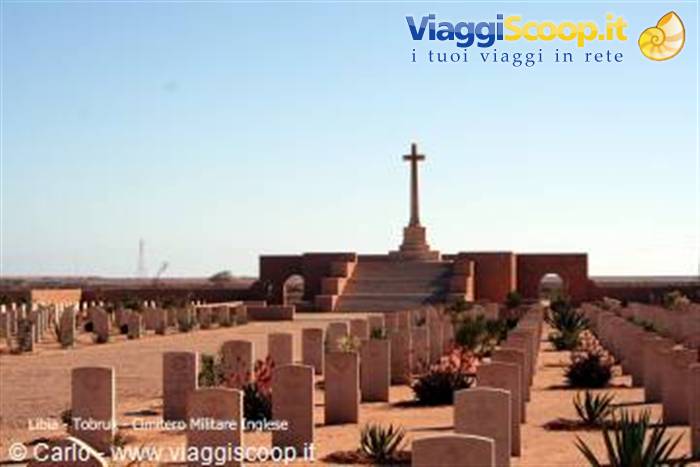 British war cemetery at Tobruk: stone cross, rows of headstones, sand