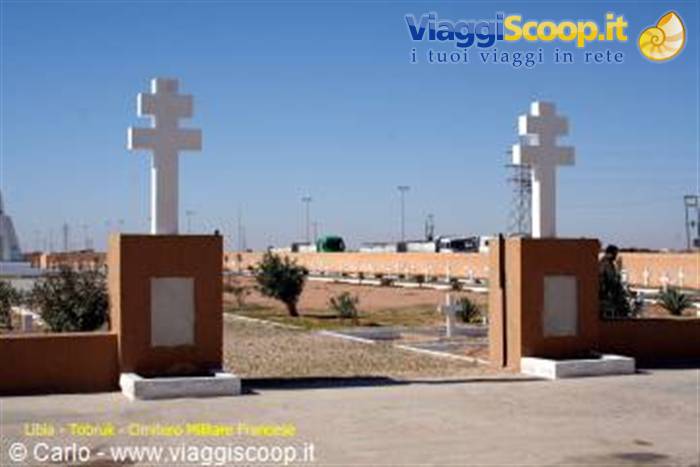 Tobruk French cemetery: two white crosses on ochre pillars under blue sky