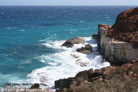 Turquoise waves crash on the limestone cliffs near the Basilicas Pitiantine