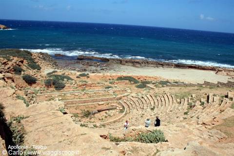Roman stone theatre at Apollonia, tourists on the tiers facing the sea