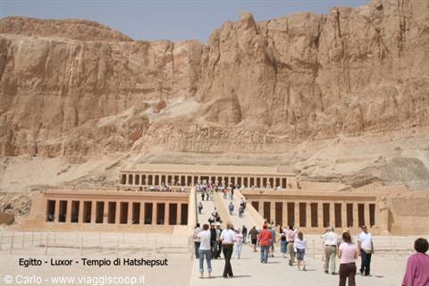 Tourists on the ramp of Hatshepsut Temple in Luxor, ochre limestone in sunlight