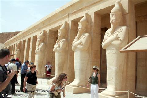 Tourists beneath Hatshepsut statues at Deir el-Bahari temple