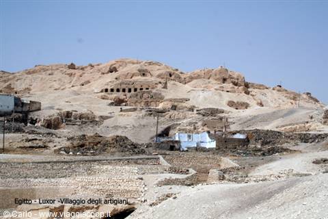 Artisans' village amid desert hills in Luxor, mud-brick houses under clear sky