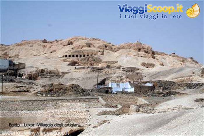 Artisans' village amid desert hills in Luxor, mud-brick houses under clear sky