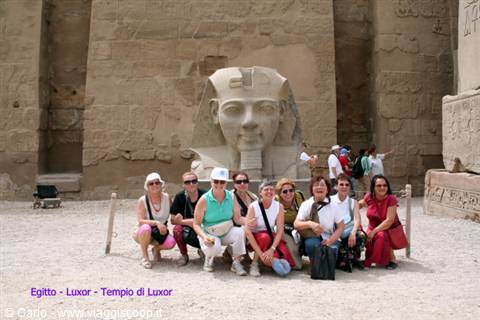 Tourists posing before the Ramses II statue, Luxor Temple