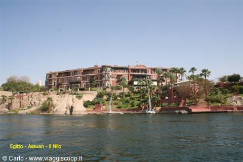 Red-brick hotel on the Nile bank, moored feluccas, Aswan