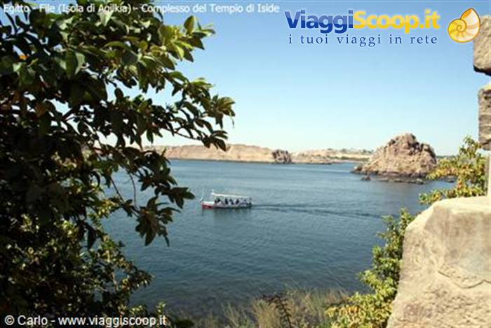 Boat crossing blue waters near Philae Temple, Aswan
