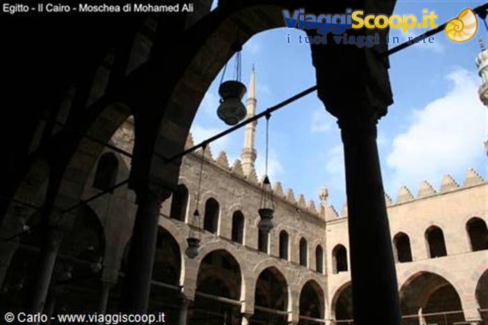 Courtyard of Mohamed Ali Mosque in Cairo, stone arches and minaret