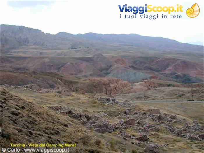 Dry hills and scattered stones near Camping Murat
