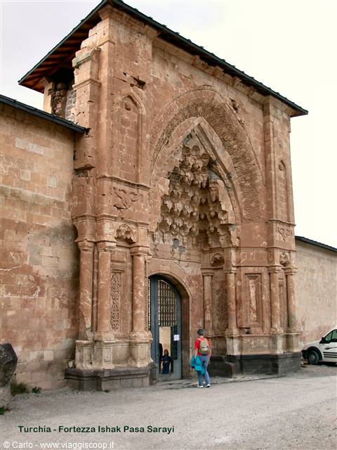 Tourist entering the carved stone portal of Ishak Pasha Palace
