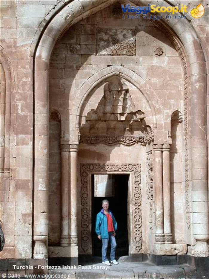 Tourist beneath the carved stone portal of Ishak Pasha Palace