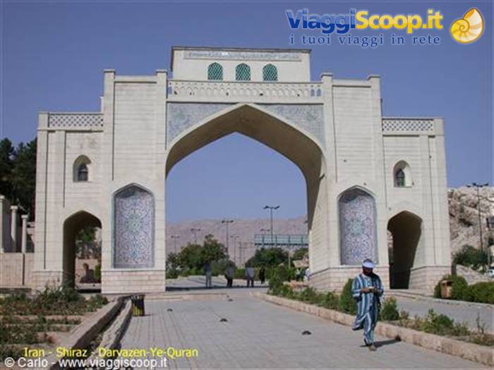 Quran Gate in Shiraz, blue tiled arch, a visitor walks beneath it