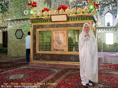 Veiled pilgrim beside the mirrored shrine in Shah-e Cheragh mausoleum, Shiraz