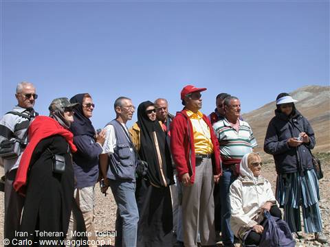 Group of tourists hiking on Mount Tochal, Tehran, under sunny skies