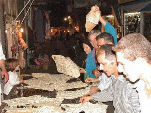 Ramsar bazaar: men selecting sangak flatbread at the stall