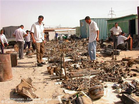 Tolkuchka bazaar in Ashgabat: men browsing scrap metal and used parts