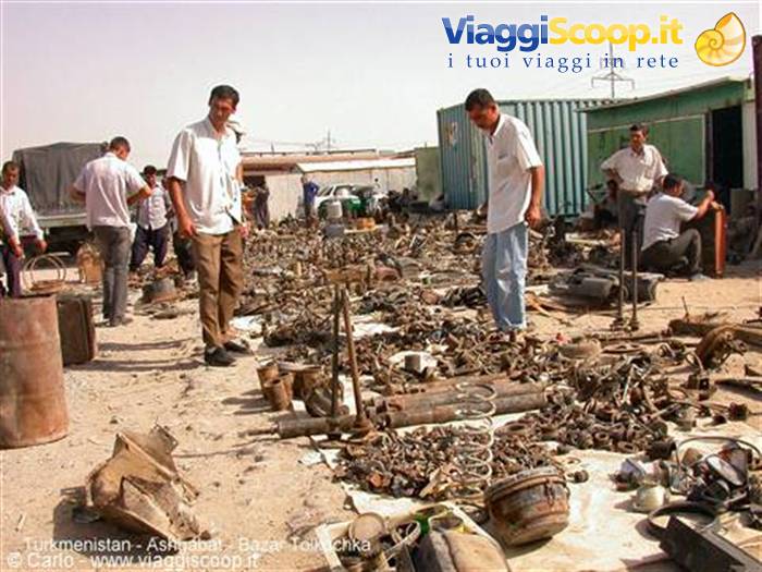 Tolkuchka bazaar in Ashgabat: men browsing scrap metal and used parts