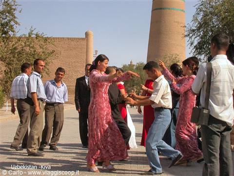 Traditional dancers in front of the Islam Khoja minaret, Khiva