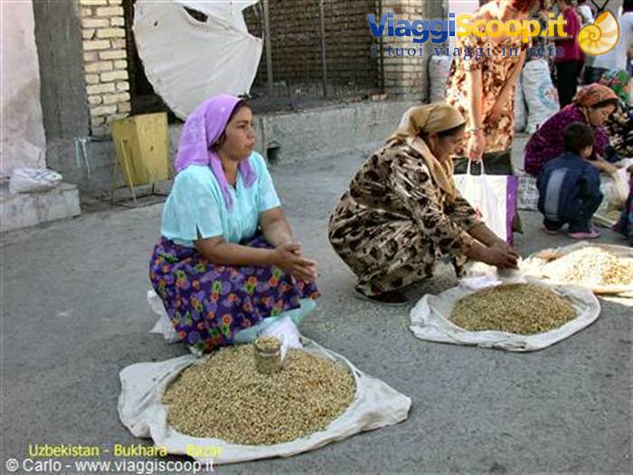 Women in headscarves selling grains at Bukhara market