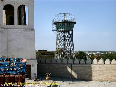 Steel water tower in Bukhara, brick walls and souvenir stall