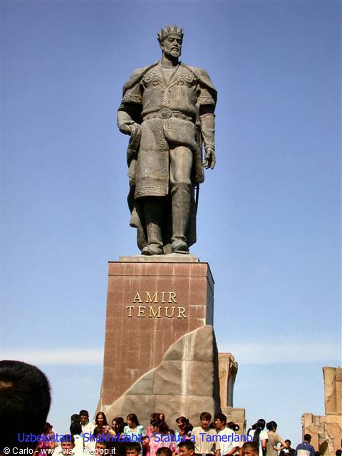 Amir Temur statue in Shakhrisabz, bronze figure on pedestal under blue sky