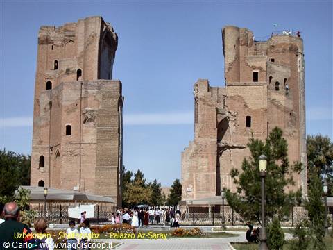 Tourists beneath the brick ruins of Ak-Saray Palace in Shakhrisabz