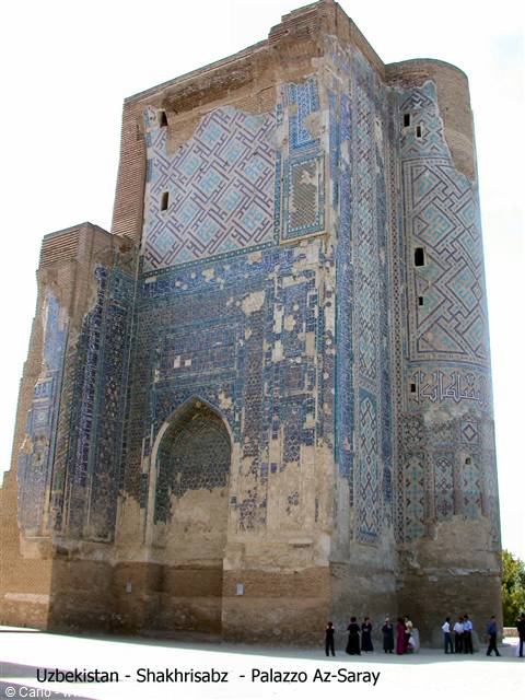 Tourists beneath the huge brick portal with blue tiles of Ak-Saray palace, Shakhrisabz