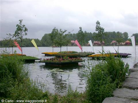 Floating islands with flowers and trees on the lake, colorful flags