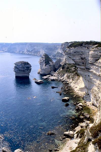 Limestone cliffs of Bonifacio over blue sea with sea stacks