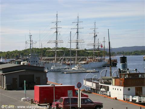 Tall ships moored at Oslo harbour, beside a vintage steamer ferry