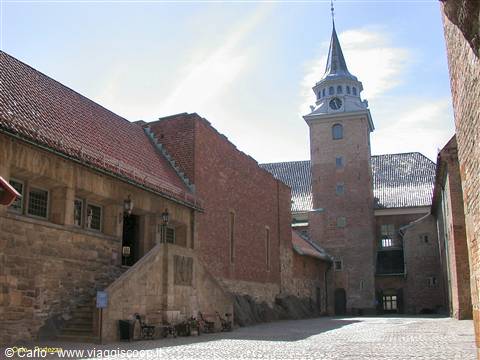 Brick courtyard with clock tower and sloping roof, Akershus, Oslo